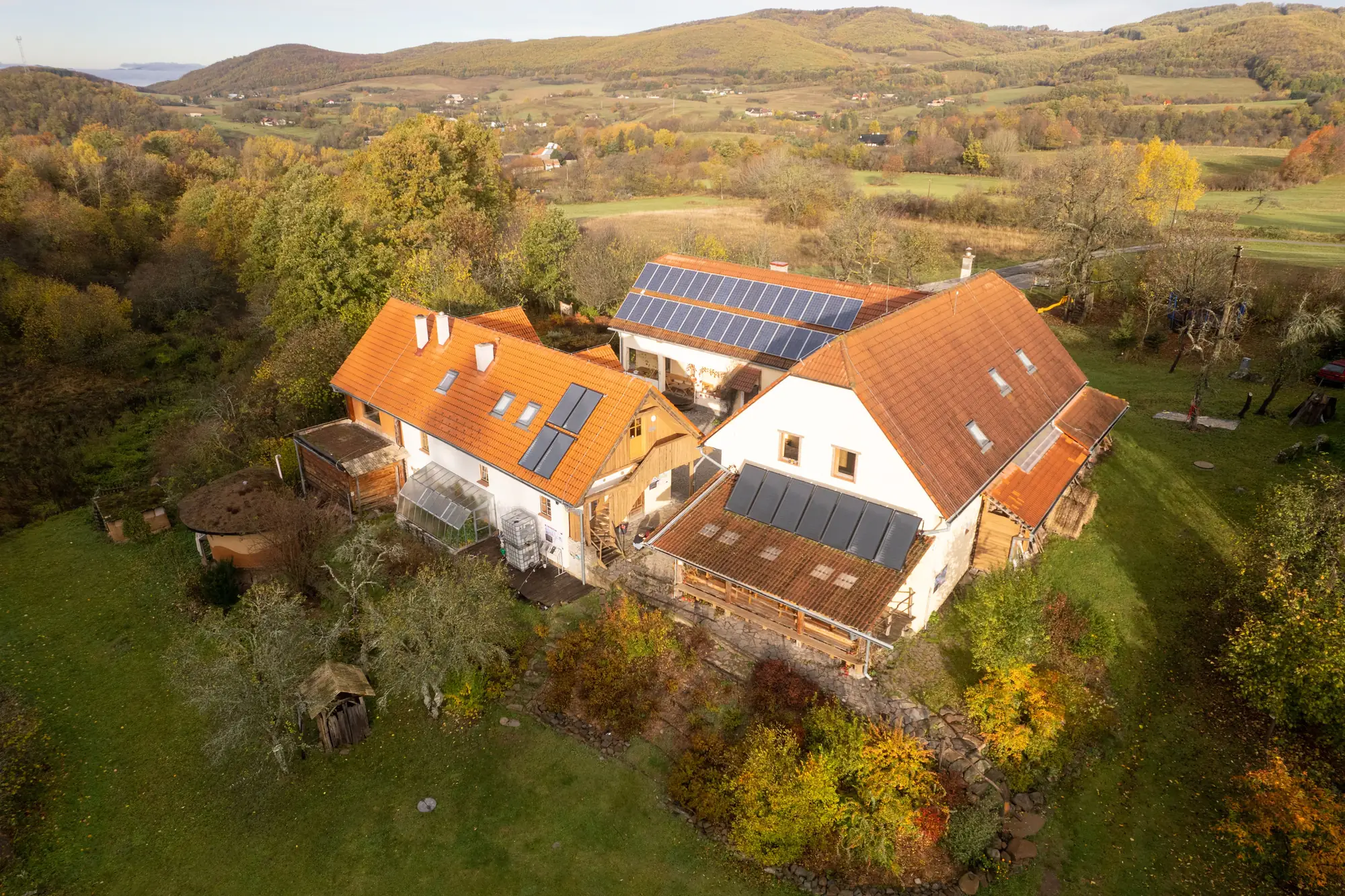 Aerial view of a large home with a full rooftop solar array