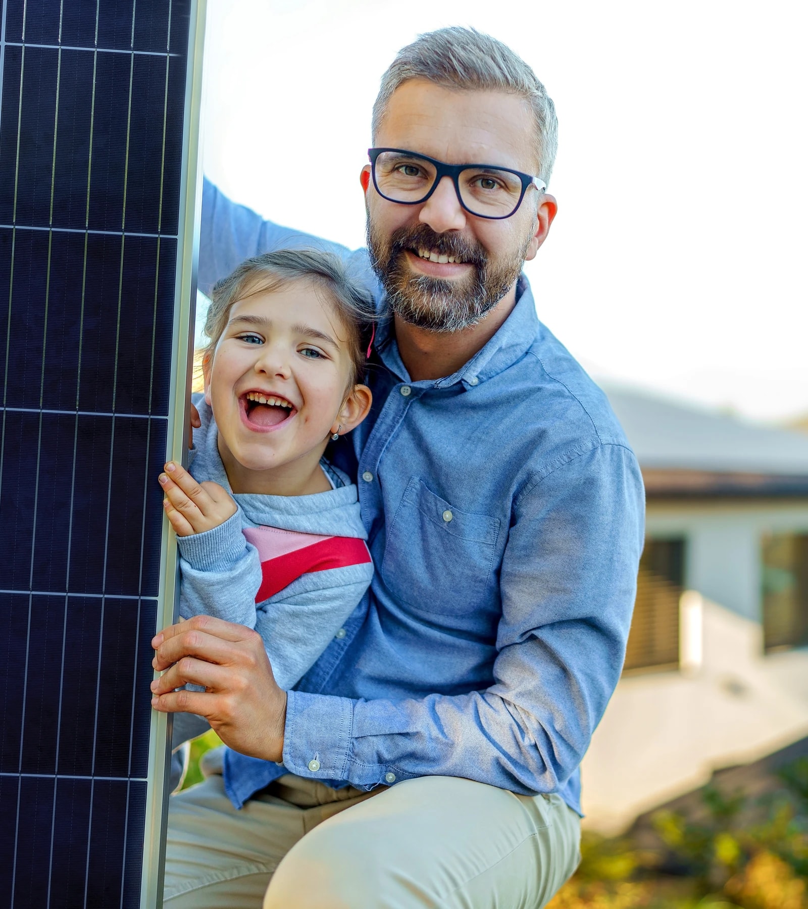 A family outside their home looking up at its rooftop solar array